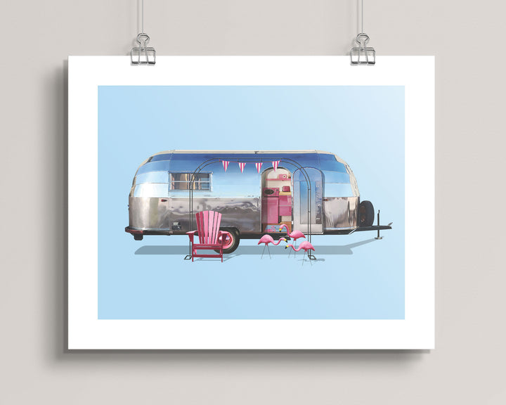 hanging artwork of a vintage 1948 Airstream Liner Camping Trailer with pink chairs and flamingos on a light blue background.