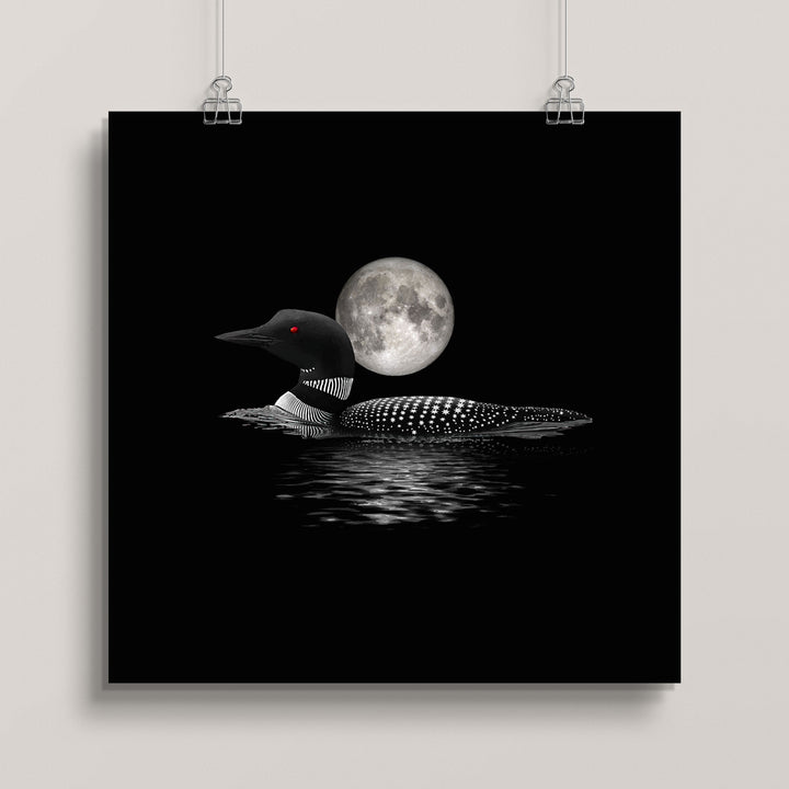 Hanging artwork of a loon with a full moon in the background titled Lunar Loon