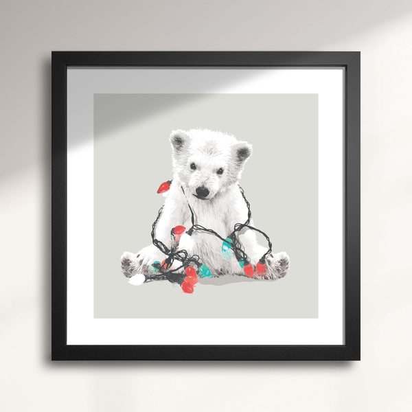 Framed artwork of a polar bear with Christmas lights on a gray background titled Northern Lights Polar Bear