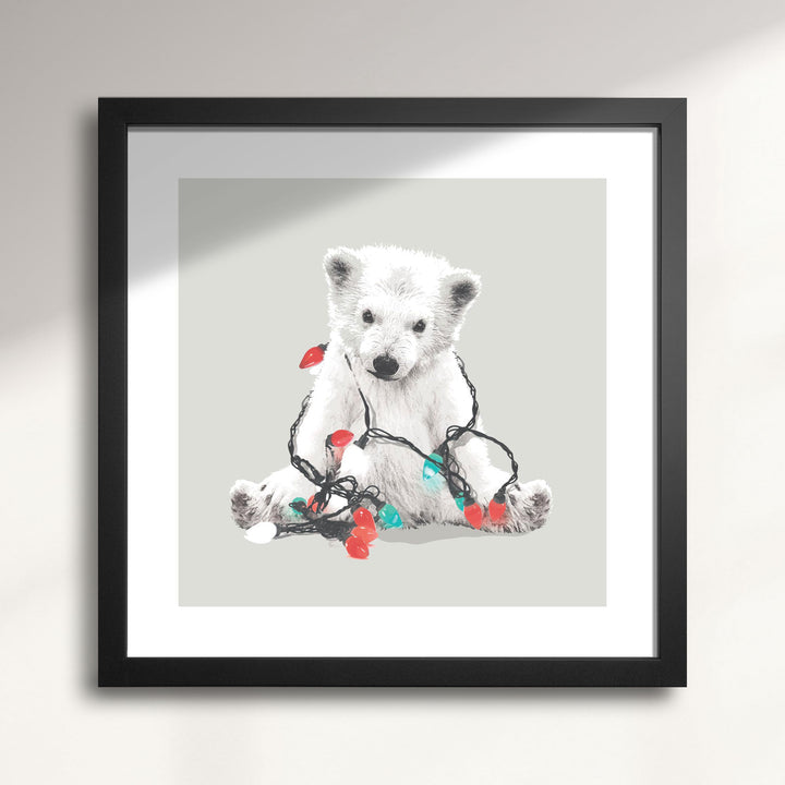 Framed artwork of a polar bear with Christmas lights on a gray background titled Northern Lights Polar Bear