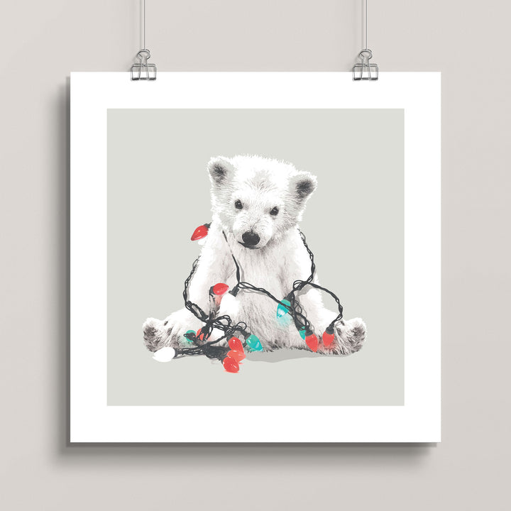 Hanging artwork of a polar bear with Christmas lights on a gray background titled Northern Lights Polar Bear
