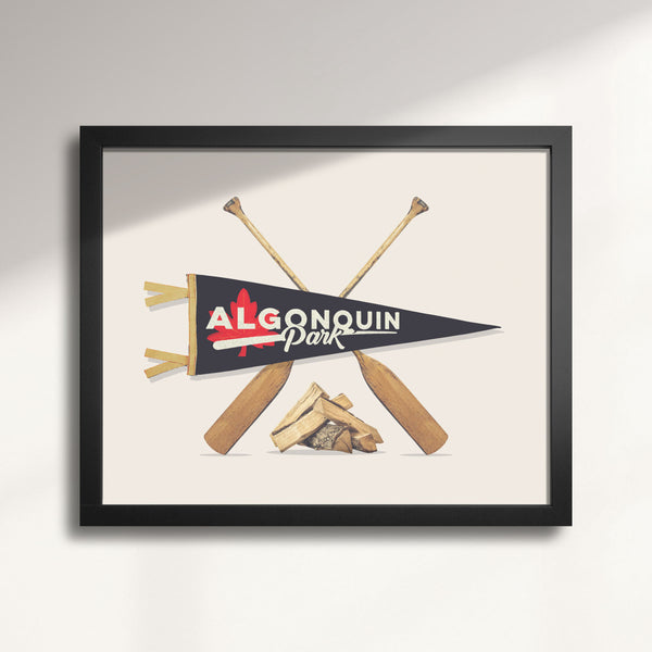 Framed artwork with Algonquin Park pennant and paddles on a beige background