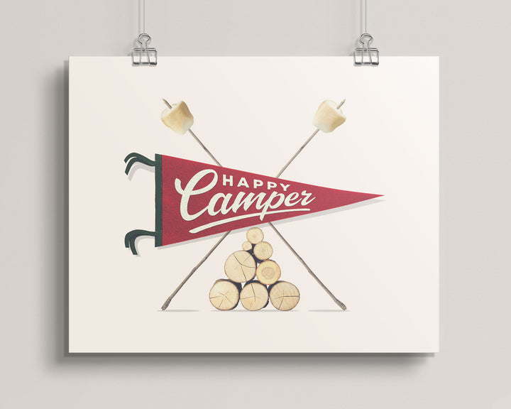 Hanging artwork with 'Happy Camper' design featuring a red banner, crossed marshmallow sticks, and stacked logs on a light background, titled Happy Camper Pennant