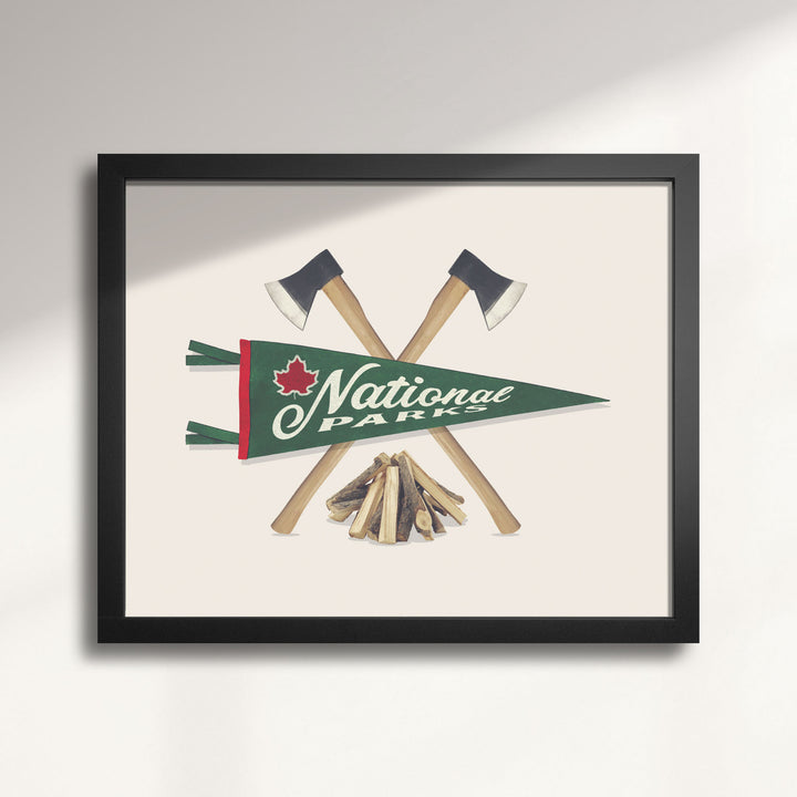 Framed artwork with crossed axes, a campfire, and a National Parks pennant on a beige background titled National Parks Pennant