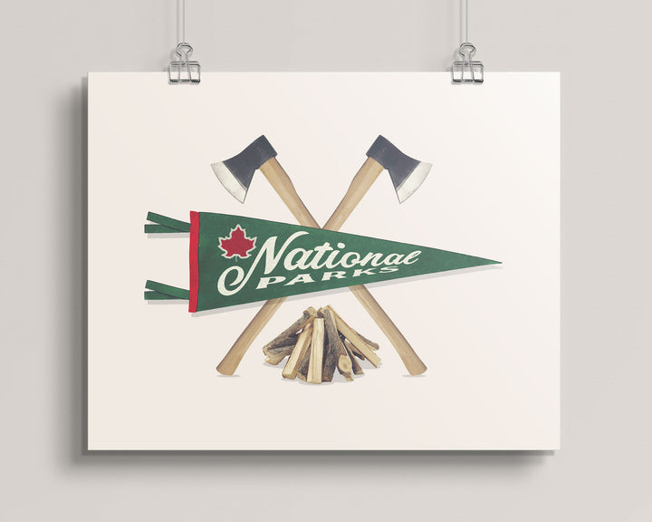 Hanging artwork with crossed axes, a campfire, and a National Parks pennant on a beige background titled National Parks Pennant